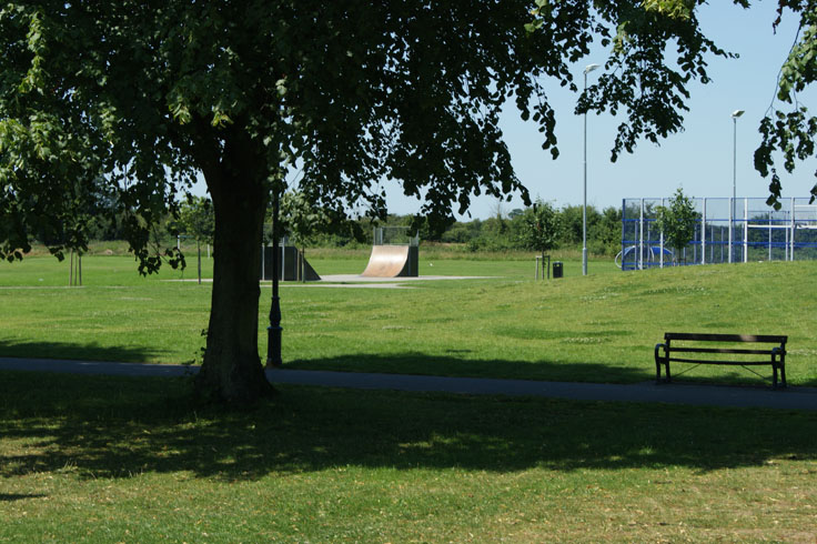 A bike ramp and play area in a park.